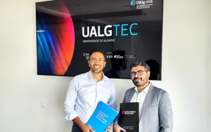 Zeyn Angamia with Hugo Barros stand in front of the UALGTEC banner after the signing.