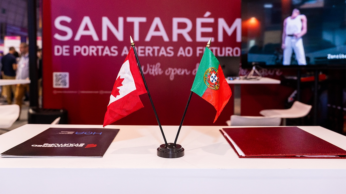 The Canadian and Portuguese flags stand beside the signed MOUs.