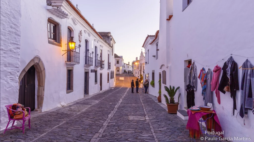This extremely beautiful mediaeval town has succeeded in preserving its own distinctive characteristics over the centuries. Walking through the streets of Monsaraz is like going back in time, for it is a truly unique place where one can find all the peace and tranquillity that have been forgotten by the modern era. The most immediate visual impression in the town is that of the whitewash and schist of its houses and buildings. Every year, throughout the month of July, Monsaraz becomes an open-air museum, affording visitors the opportunity to get to know more about the customs and habits used in the production of Alentejo handicraft, appreciate the delights of the regional cuisine and enjoy the various cultural events that are held there, including music, theatre, dance and art exhibitions(Source: visitportugal.)